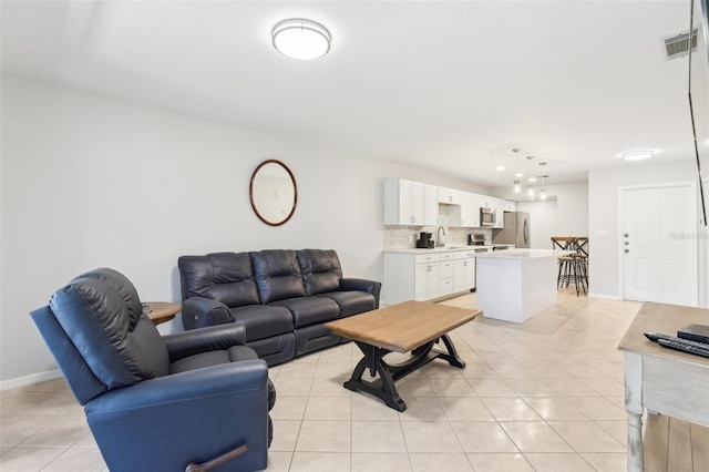 living room with light tile patterned flooring, baseboards, and visible vents