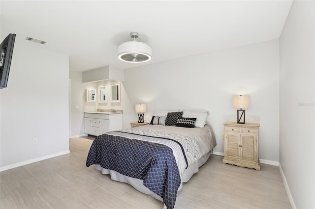 bedroom featuring visible vents, baseboards, and light wood-style floors