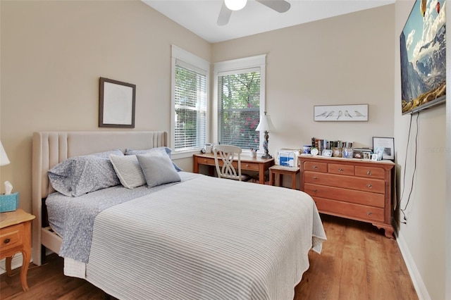 bedroom featuring baseboards, a ceiling fan, and wood finished floors
