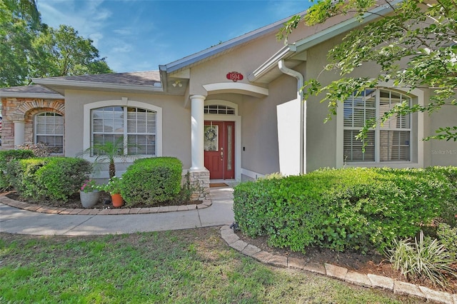 entrance to property with stucco siding