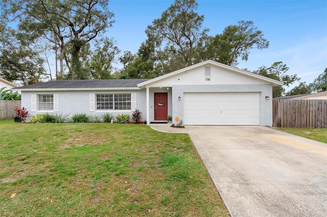 732 Mockingbird Ln, Deland, FL 32720 - single story home with an attached garage, fence, a front lawn, and concrete driveway