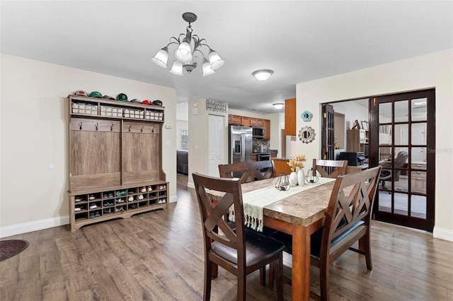 732 Mockingbird Ln, Deland, FL 32720 - dining room featuring wood finished floors, an inviting chandelier, baseboards, and a wealth of natural light