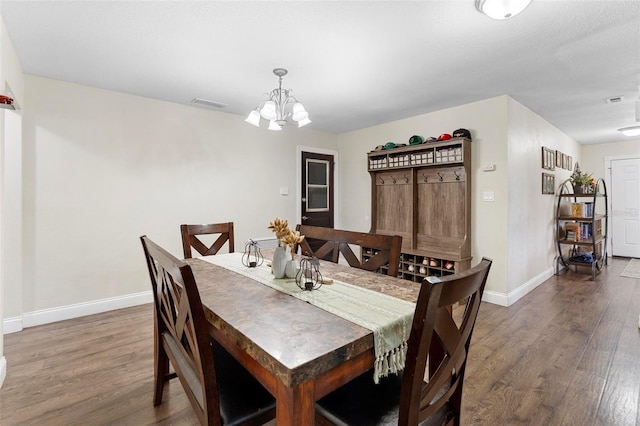 732 Mockingbird Ln, Deland, FL 32720 - dining space featuring visible vents, baseboards, an inviting chandelier, and wood finished floors