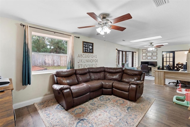 732 Mockingbird Ln, Deland, FL 32720 - living room with baseboards, a ceiling fan, visible vents, a skylight, and wood finished floors