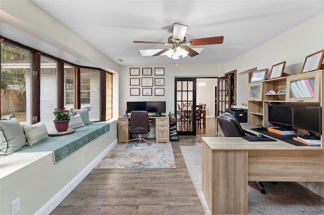 732 Mockingbird Ln, Deland, FL 32720 - office area with french doors, baseboards, a ceiling fan, and wood finished floors
