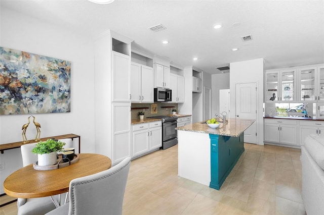 kitchen with white cabinets, recessed lighting, stainless steel microwave, tasteful backsplash, and electric range