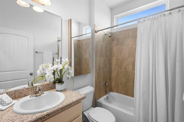 full bathroom featuring shower / tub combo with curtain, toilet, and vanity