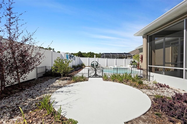 view of patio / terrace with a fenced backyard, a fenced in pool, and a sunroom
