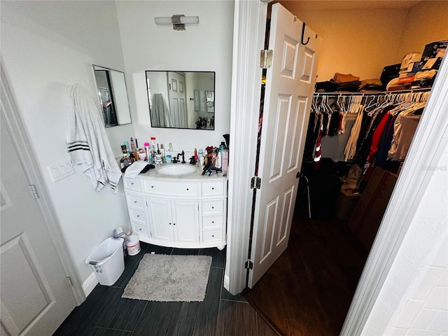 606 W Voorhis Ave, Deland, FL 32720 - bathroom featuring a spacious closet, vanity, and wood finished floors