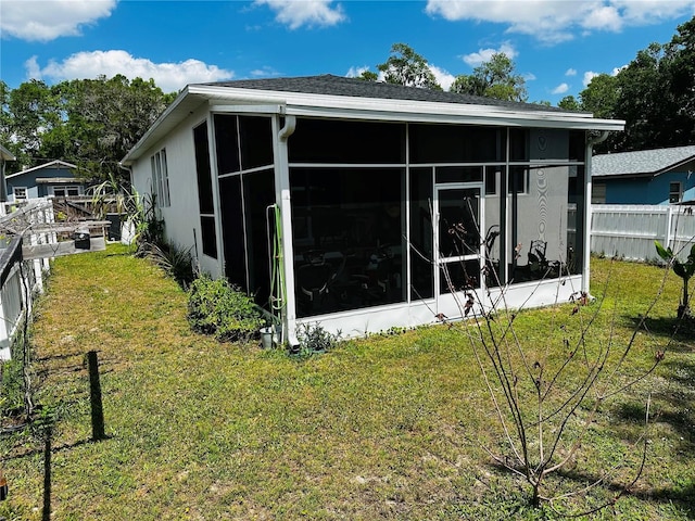 606 W Voorhis Ave, Deland, FL 32720 - exterior space featuring a sunroom, fence, and a lawn