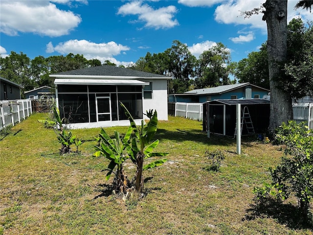 606 W Voorhis Ave, Deland, FL 32720 - view of yard with a storage shed, a sunroom, a fenced backyard, and an outdoor structure