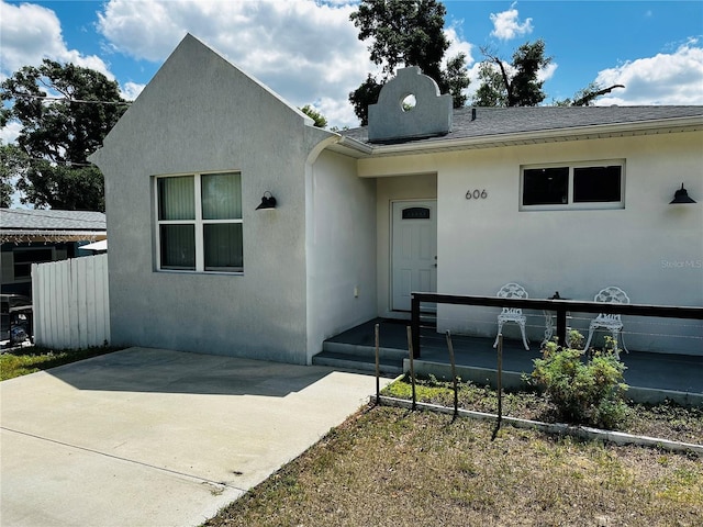 606 W Voorhis Ave, Deland, FL 32720 - view of front of home featuring a patio, roof with shingles, and stucco siding