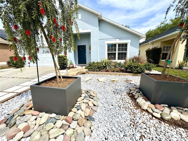 4339 Northern Dancer Way, Orlando, FL 32826 - view of front of property with driveway, stucco siding, and a garage