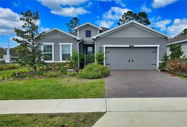 1002 Chelan Falls Dr, Deland, FL 32724 - single story home featuring stucco siding, a front lawn, decorative driveway, and a garage