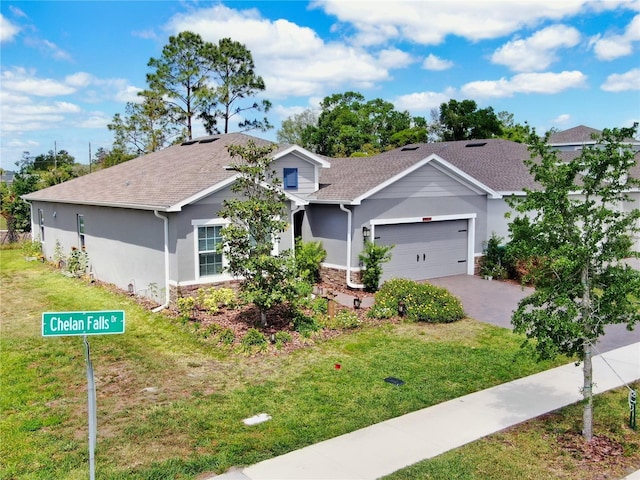 1002 Chelan Falls Dr, Deland, FL 32724 - ranch-style home with a garage, stone siding, a front lawn, and stucco siding