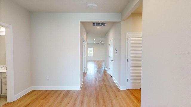 1002 Chelan Falls Dr, Deland, FL 32724 - hallway with light wood-style flooring, visible vents, and baseboards