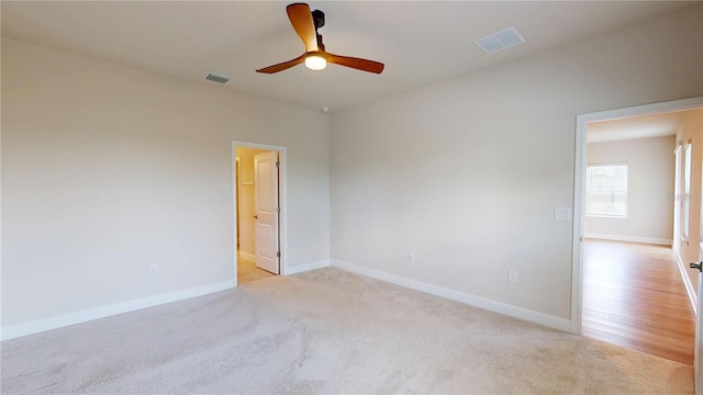 1002 Chelan Falls Dr, Deland, FL 32724 - unfurnished room with light colored carpet, ceiling fan, baseboards, and visible vents