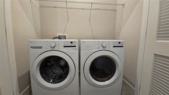 1002 Chelan Falls Dr, Deland, FL 32724 - washroom with baseboards and washer and clothes dryer