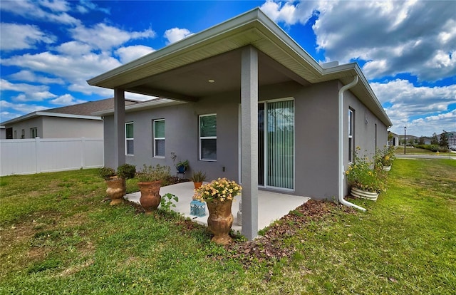 1002 Chelan Falls Dr, Deland, FL 32724 - back of house featuring a lawn, a patio, and stucco siding