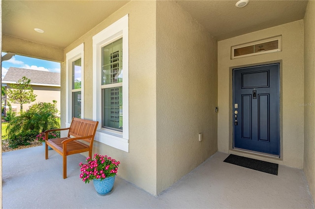 2901 Monaghan Dr, Ormond Beach, FL 32174 - view of exterior entry with a porch and stucco siding