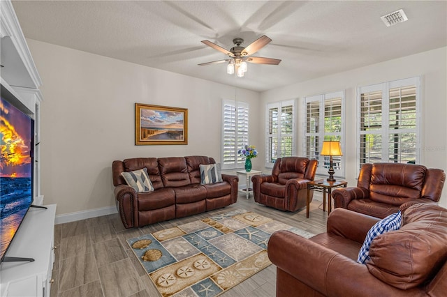 2901 Monaghan Dr, Ormond Beach, FL 32174 - living room featuring ceiling fan, wood finish floors, visible vents, and baseboards