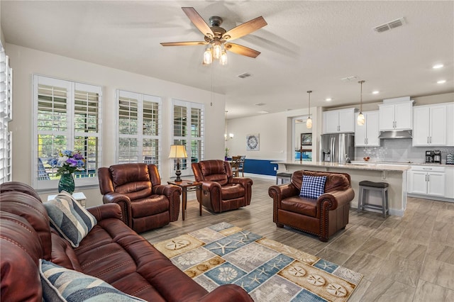 2901 Monaghan Dr, Ormond Beach, FL 32174 - living room featuring ceiling fan, a wealth of natural light, and visible vents