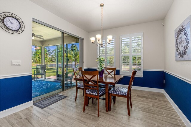 2901 Monaghan Dr, Ormond Beach, FL 32174 - dining area featuring baseboards, a chandelier, and wood tiled floor