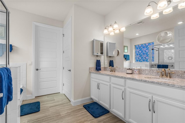 2901 Monaghan Dr, Ormond Beach, FL 32174 - full bath with a shower stall, baseboards, wood finished floors, and a sink