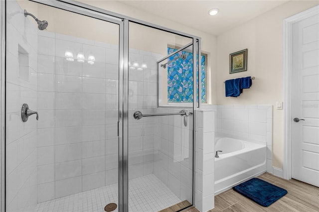 2901 Monaghan Dr, Ormond Beach, FL 32174 - full bathroom with a shower stall, a garden tub, wood finished floors, and baseboards