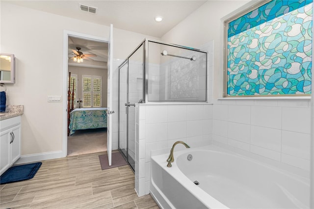 2901 Monaghan Dr, Ormond Beach, FL 32174 - ensuite bathroom featuring visible vents, a ceiling fan, vanity, ensuite bath, and a garden tub