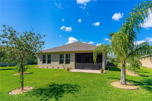2901 Monaghan Dr, Ormond Beach, FL 32174 - rear view of house with a sunroom, a yard, and stucco siding