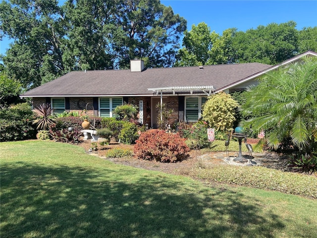 ranch-style home featuring a chimney and a front lawn