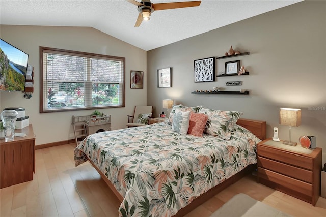 bedroom with lofted ceiling, a ceiling fan, and light wood-type flooring