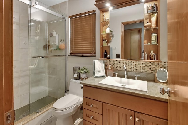 full bathroom featuring tasteful backsplash, vanity, toilet, and a stall shower