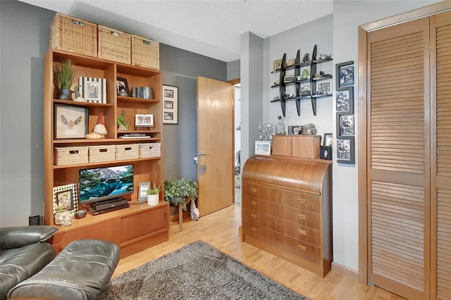interior space with wood finished floors and a textured ceiling