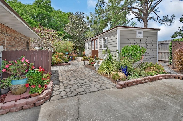 view of side of home with fence and a patio area