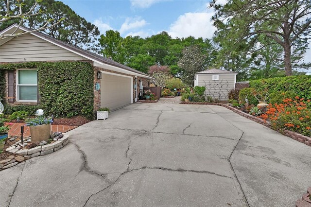 view of side of property featuring a garage and driveway