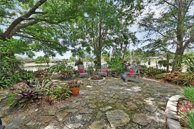 view of yard with a fire pit and a patio