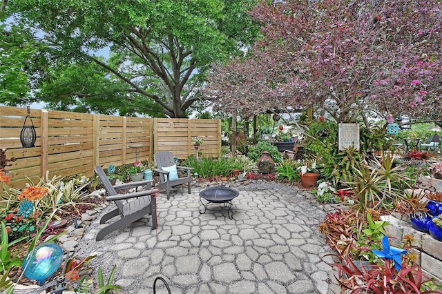 view of patio with a fire pit and fence