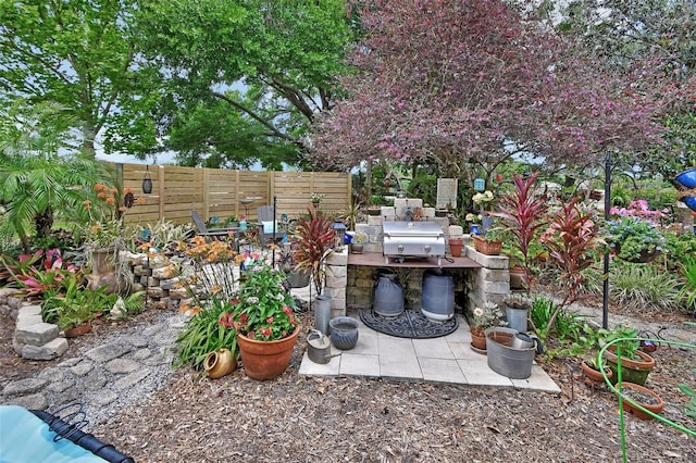 view of patio featuring fence and exterior kitchen