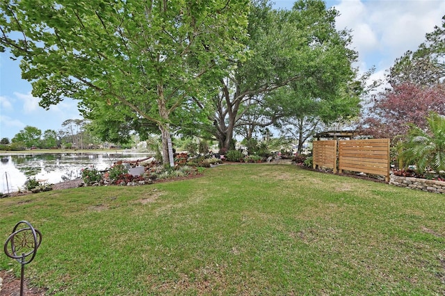view of yard with fence and a water view