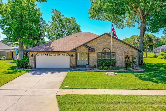 ranch-style home with roof with shingles, a front lawn, brick siding, a garage, and concrete driveway