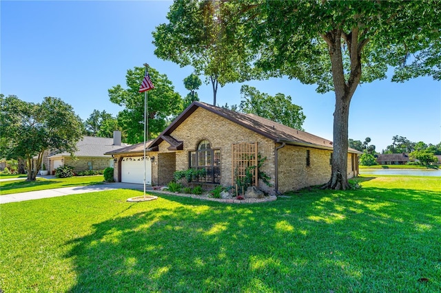view of front of house with brick siding, a garage, a front yard, and concrete driveway
