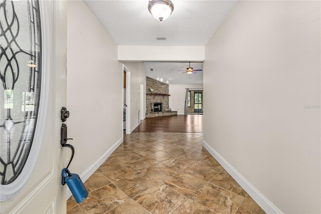 interior space featuring a textured ceiling, baseboards, and visible vents