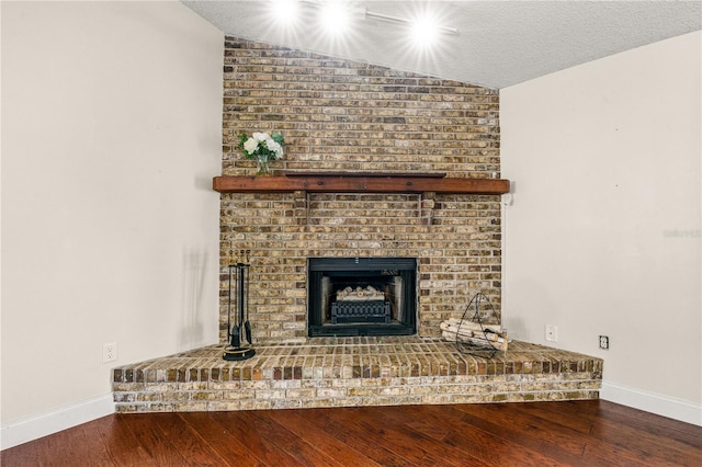unfurnished living room with baseboards, wood finished floors, and vaulted ceiling