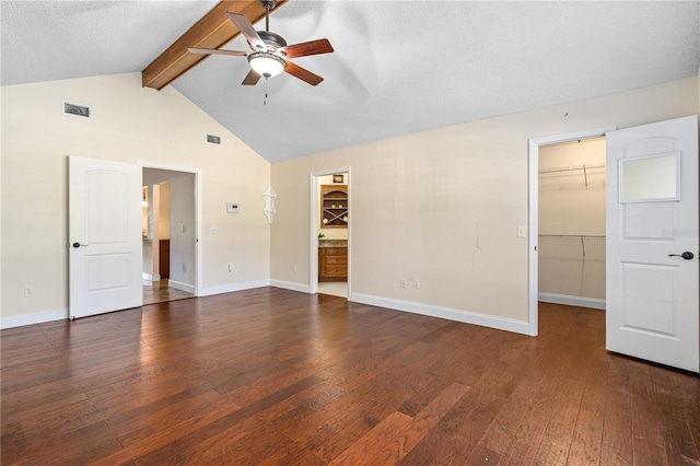 empty room with baseboards, ceiling fan, wood finished floors, and visible vents