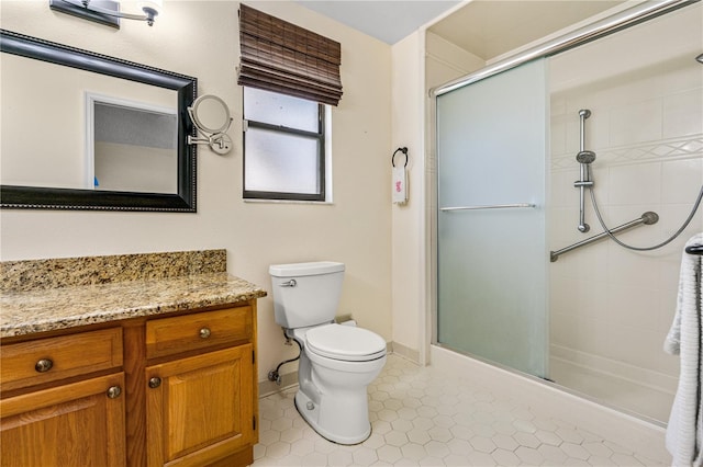 full bath with toilet, a shower stall, tile patterned flooring, and vanity