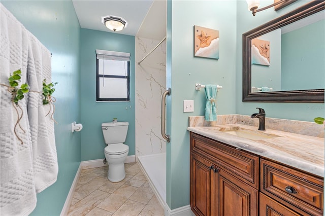 full bath featuring vanity, baseboards, toilet, and a shower stall