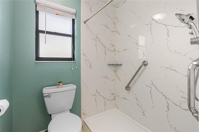 full bathroom with toilet and a marble finish shower