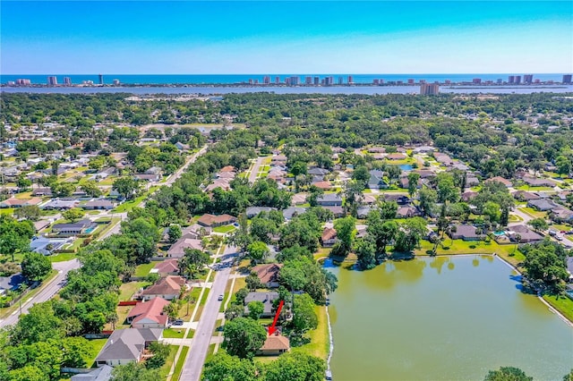 birds eye view of property with a water view, a residential view, and a city view